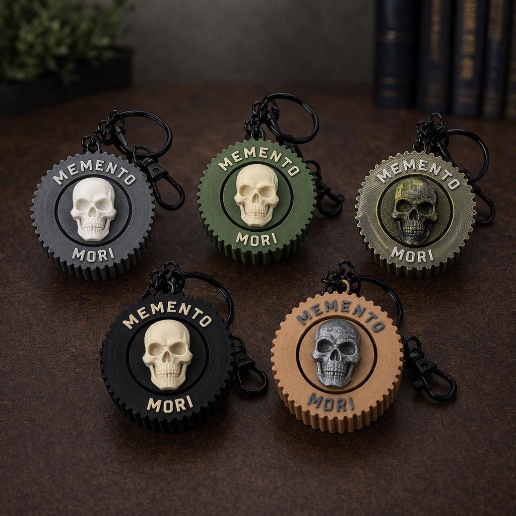 Memento mori clicker coin with a cream skull on an olive green serrated pendant, shown in five colours
